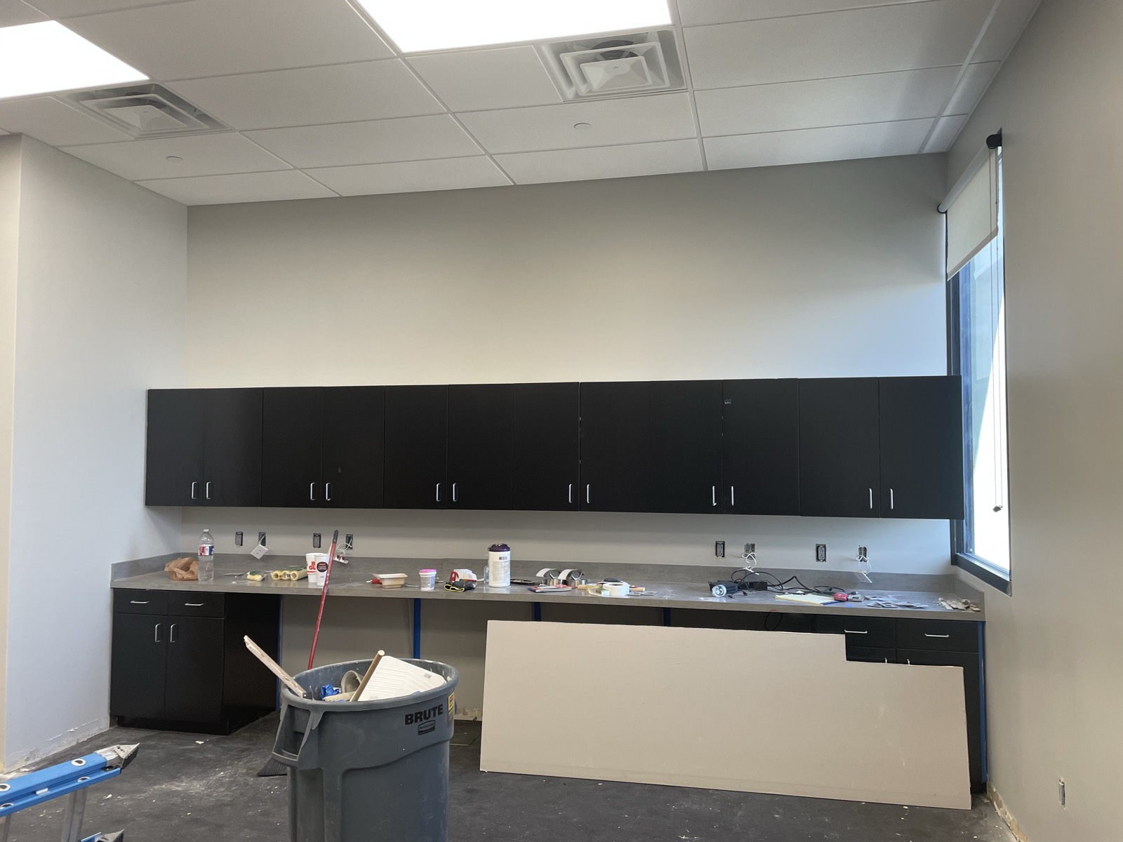 Break-room cabinetry and countertop installation during the office build-out