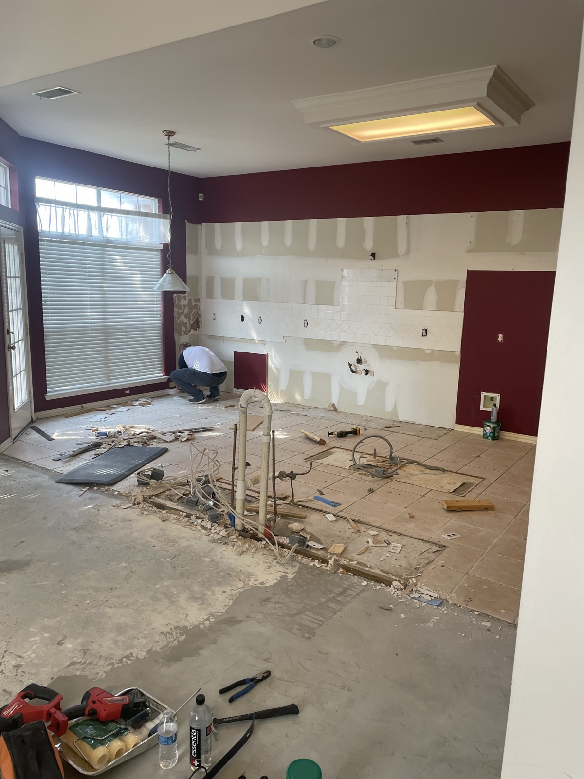 Kitchen demolition with old cabinets and tile floor removed