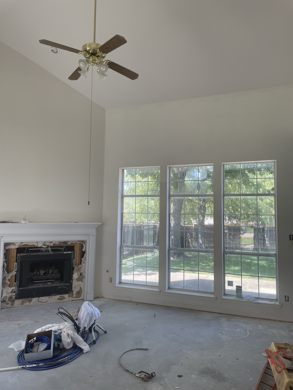 Two-story living room with fresh drywall and paint in progress